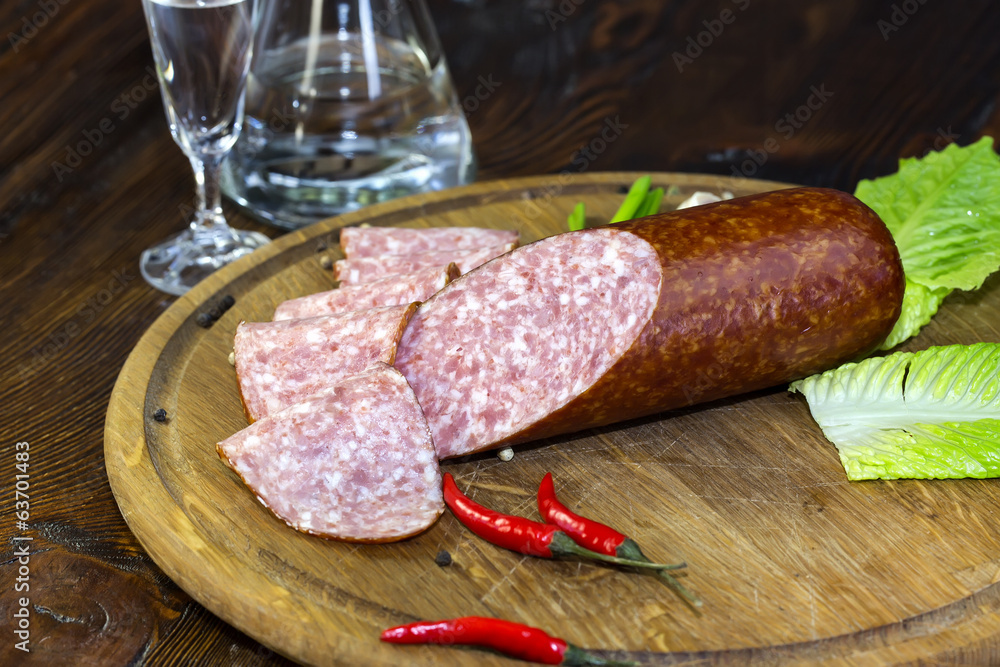 sausage on a wooden plate in a restaurant sausage on a wooden plate in a restaurant