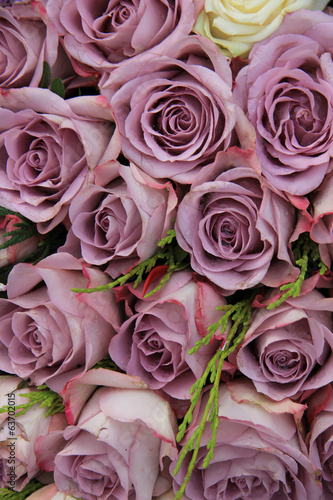 Purple roses in a wedding arrangement