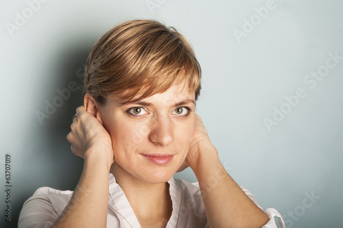 woman closing her ears