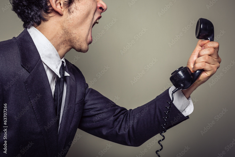 Naklejka premium Angry businessman on the phone