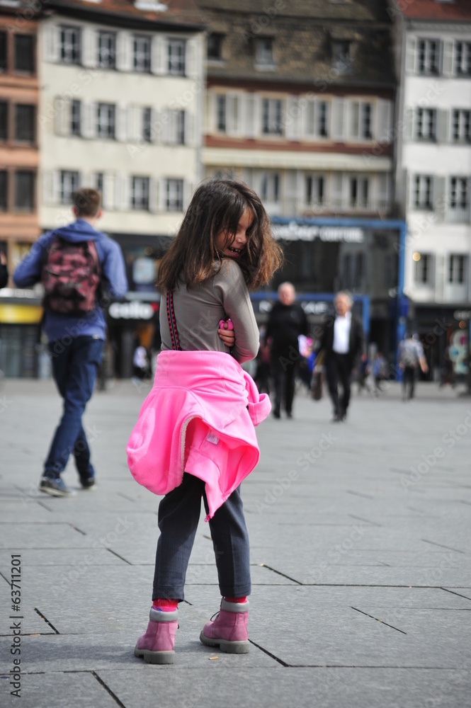 Girl spins around herself in the square Girl spins around herself in the square