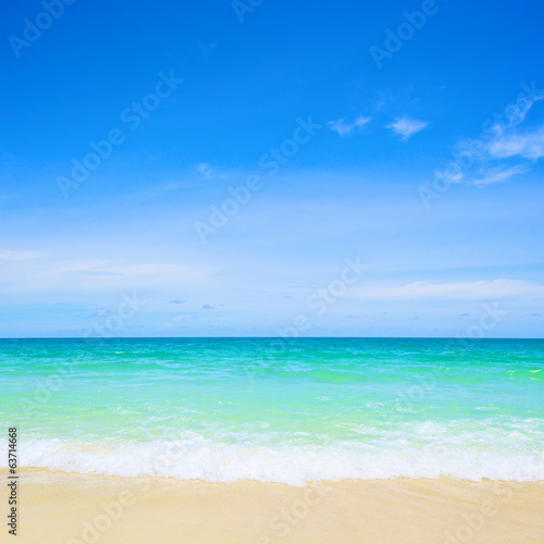 beach and tropical sea under the bright blue sky at summer day