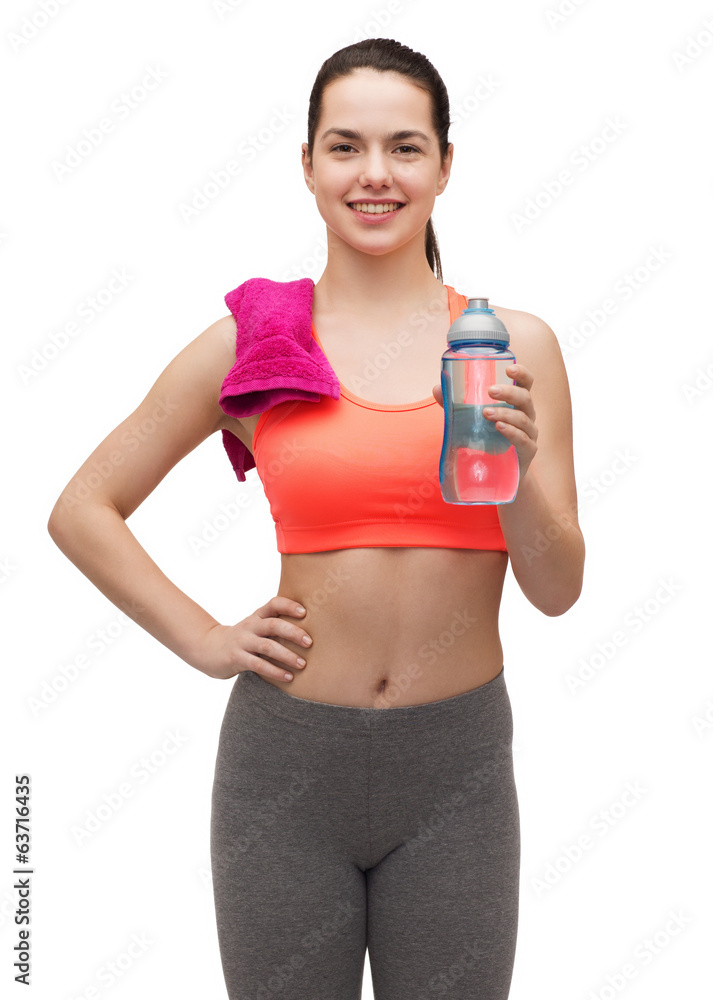 sporty woman with towel and water bottle sporty woman with towel and water bottle