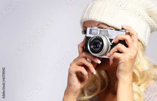 Photographer. Unrecognizable blonde young woman taking photo