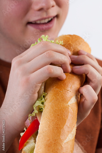 Young man eating sandwich