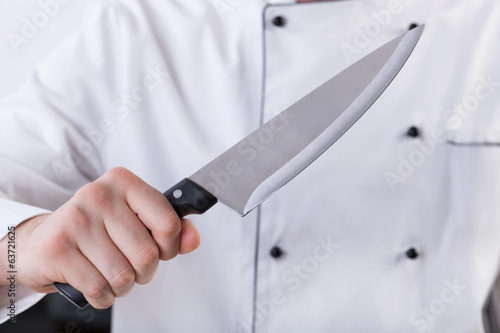 Cook holding kitchen knife