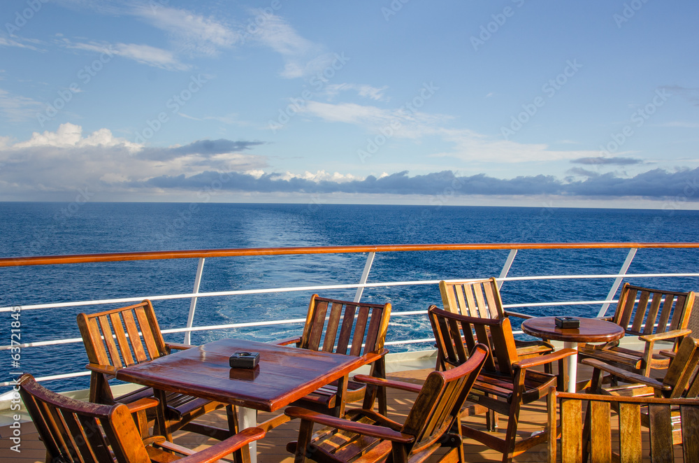 Fototapeta premium Chairs and tables on the outdoor deck of a cruise ship.