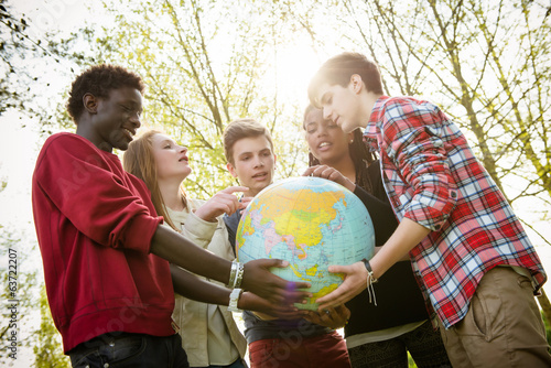 Multiracial Teen Couple Holding Globe Map