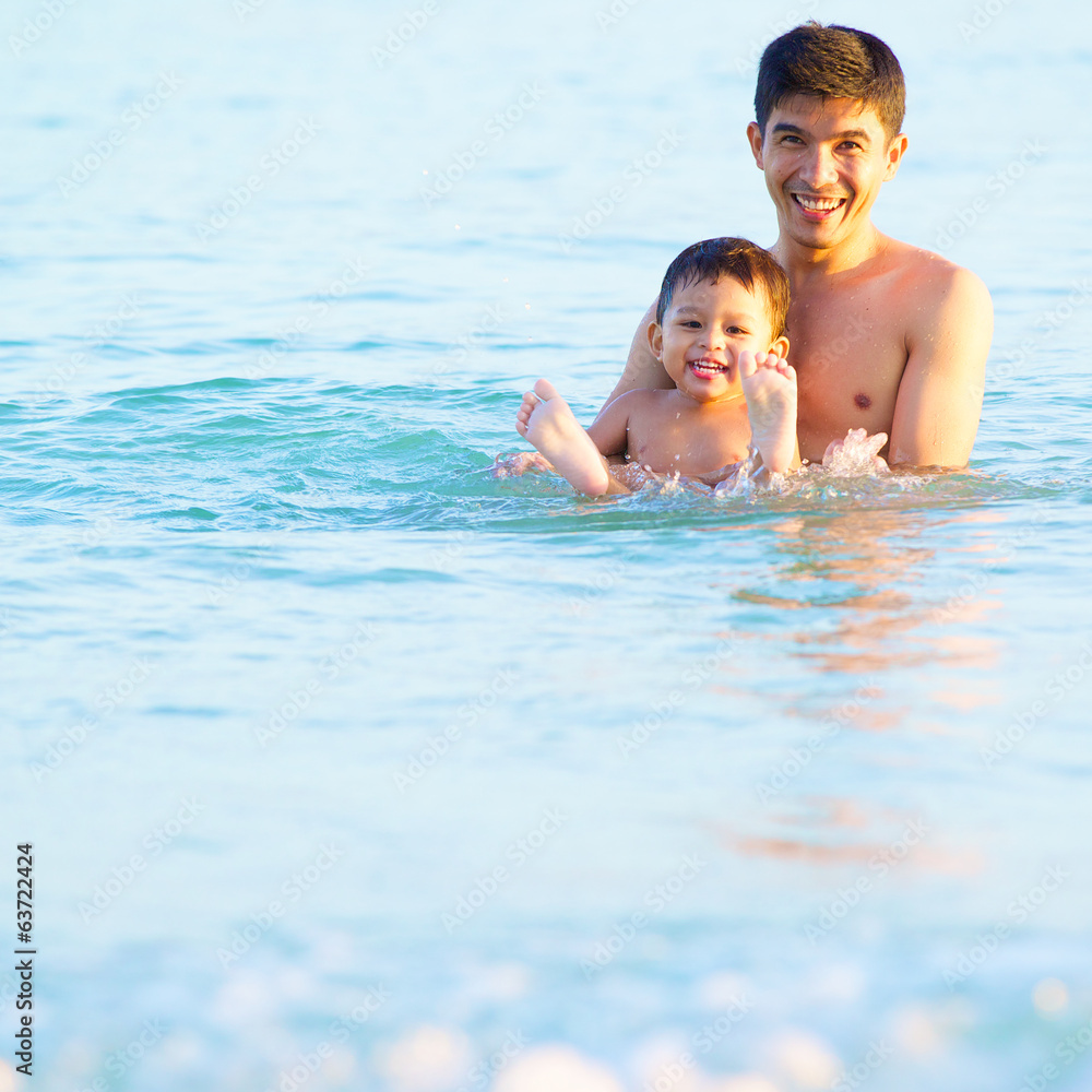 happy father and son in tropical sea, family beach vacation happy father and son in tropical sea, family beach vacation