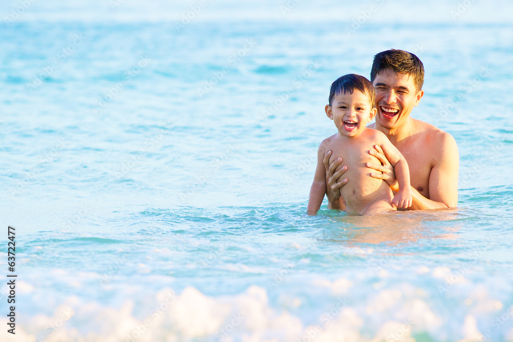 happy father and son in tropical sea, family beach vacation happy father and son in tropical sea, family beach vacation
