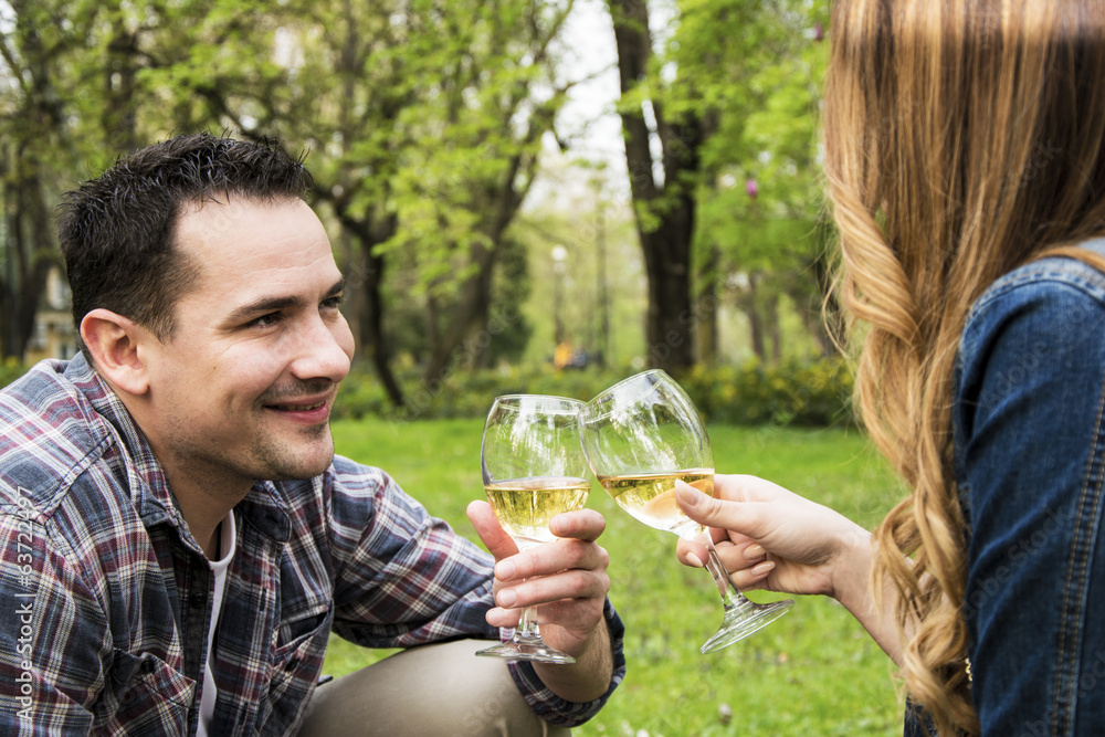 Couple toasting in park Couple toasting in park