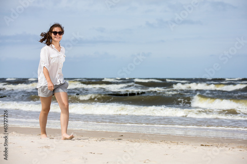 Teenage girl walking on beach