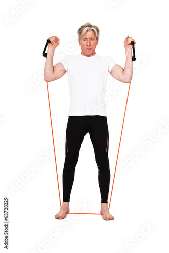 Senior fitness man exercising with orange elastics. Isolated on