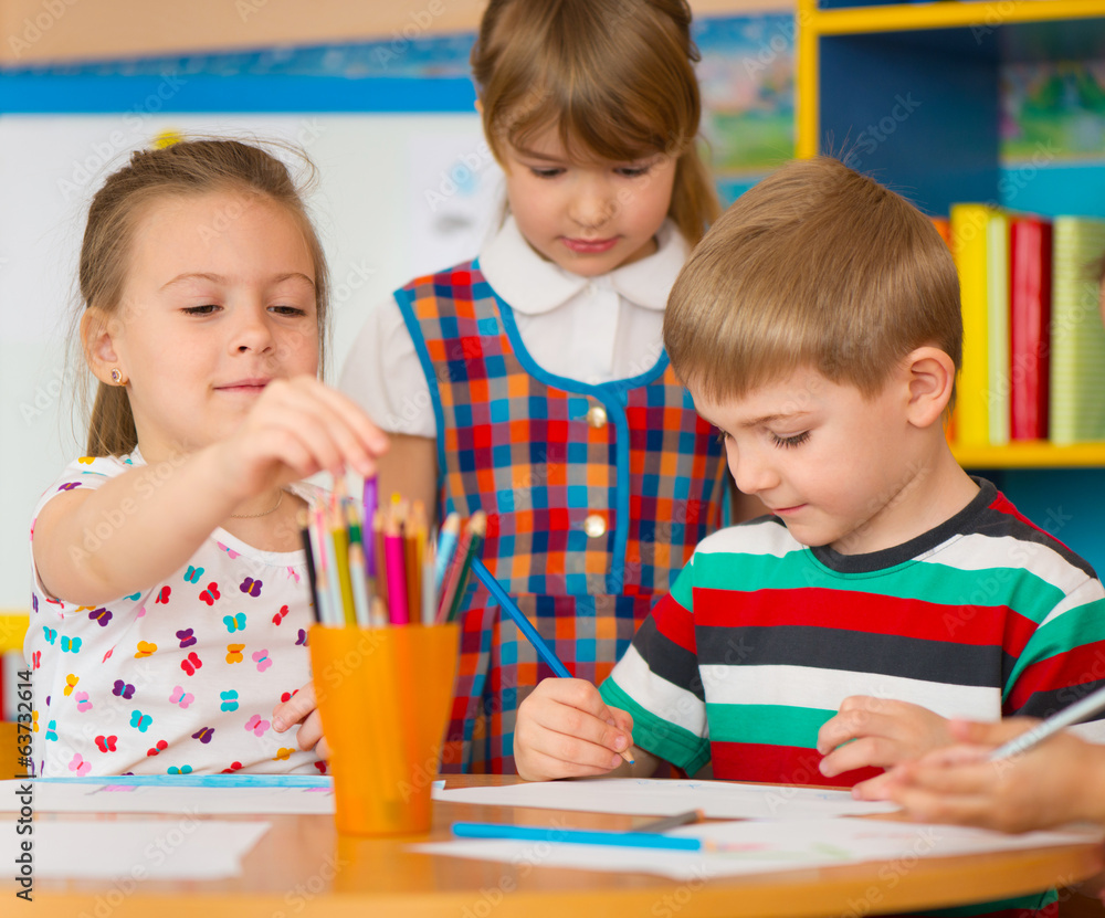 Two cute little girls drawing at school Two cute little girls drawing at school