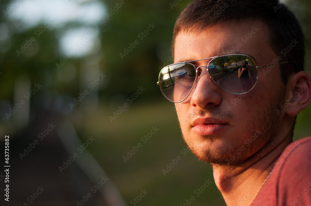 The young man smiles close up The young man smiles close up