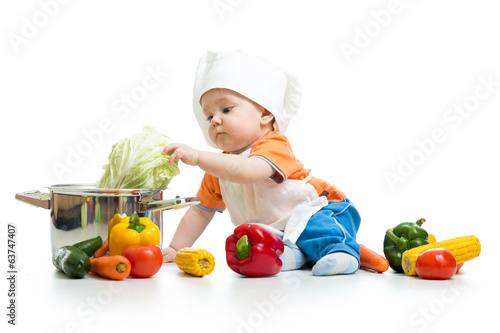 baby chef with healthy  food vegetables and pan photo