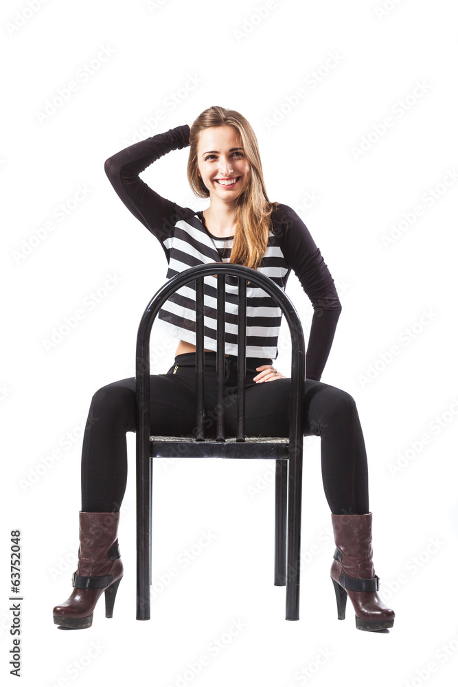 Fototapeta premium Relaxed woman sitting on a chair is smiling