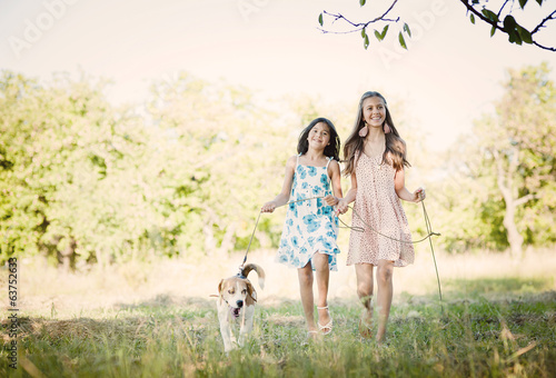 Two sisters with dog © Halfpoint