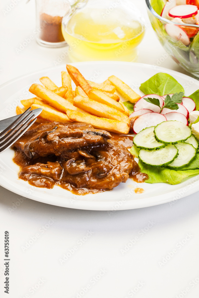 Pork chop with sauce, mushrooms and chips Pork chop with sauce, mushrooms and chips