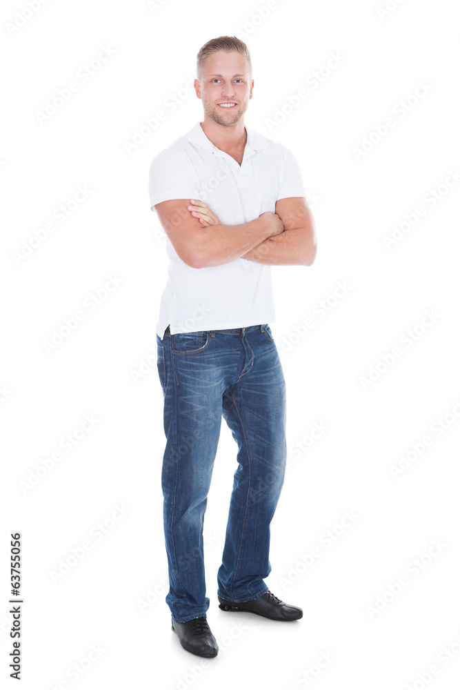 Fototapeta premium Confident sexy attractive young man in jeans and a t-shirt