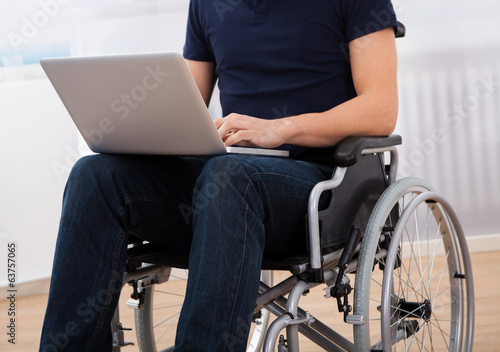 Handicapped Man Using Laptop On Wheelchair