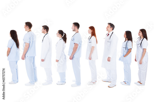 large group of medical staff standing in a queue