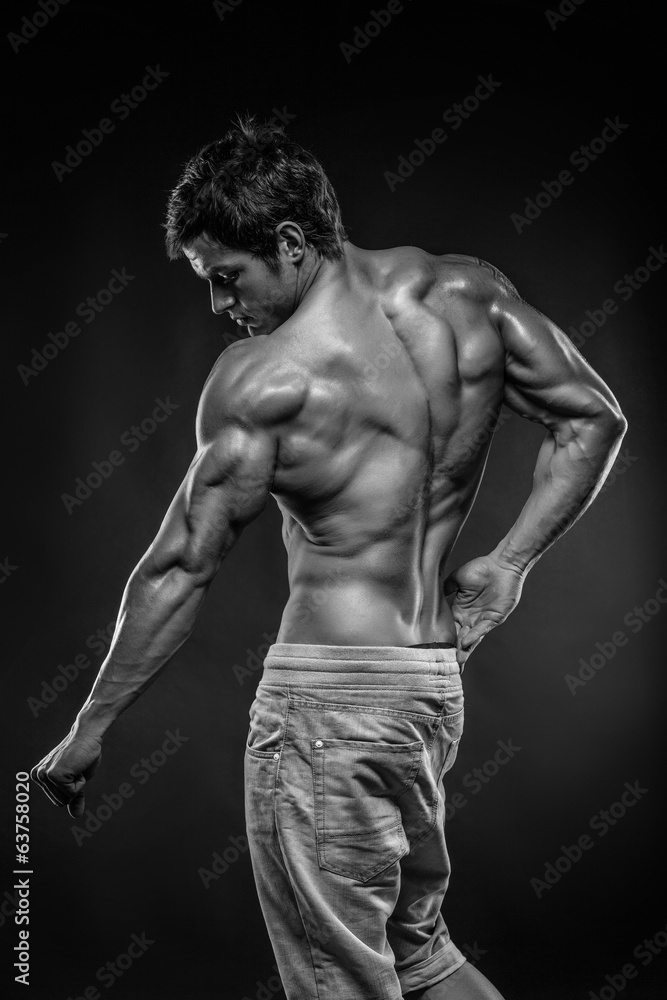 Premium Photo  Strong athletic man fitness model posing back muscles  triceps latissimus over dark background
