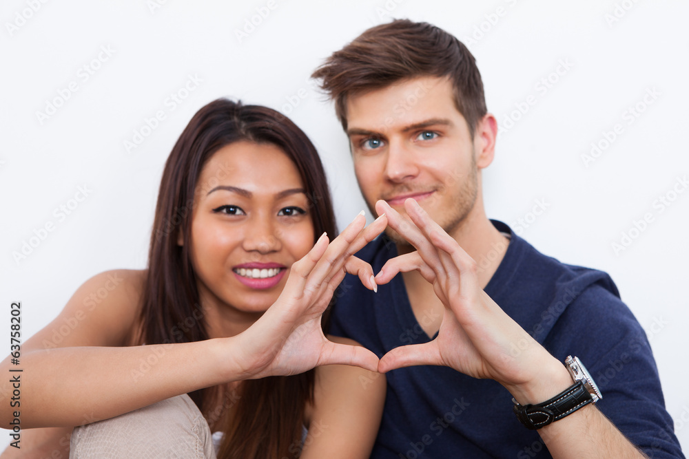 Couple Making Heart Shape With Hands