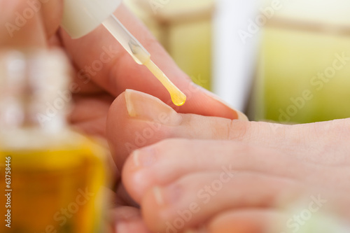Beautician Applying Nail Varnish To Woman