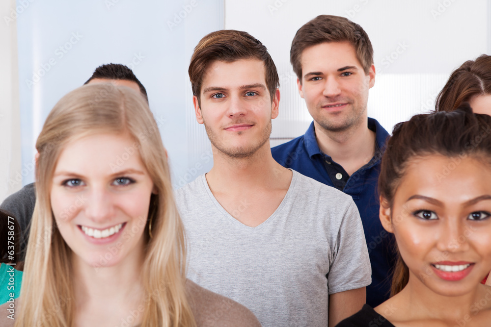 Portrait Of College Students Standing In Classroom Portrait Of College Students Standing In Classroom