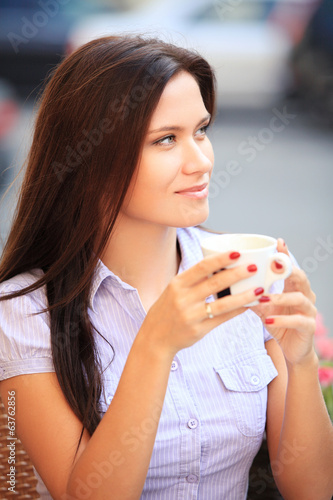 Woman drinking coffee and sitting outdoor