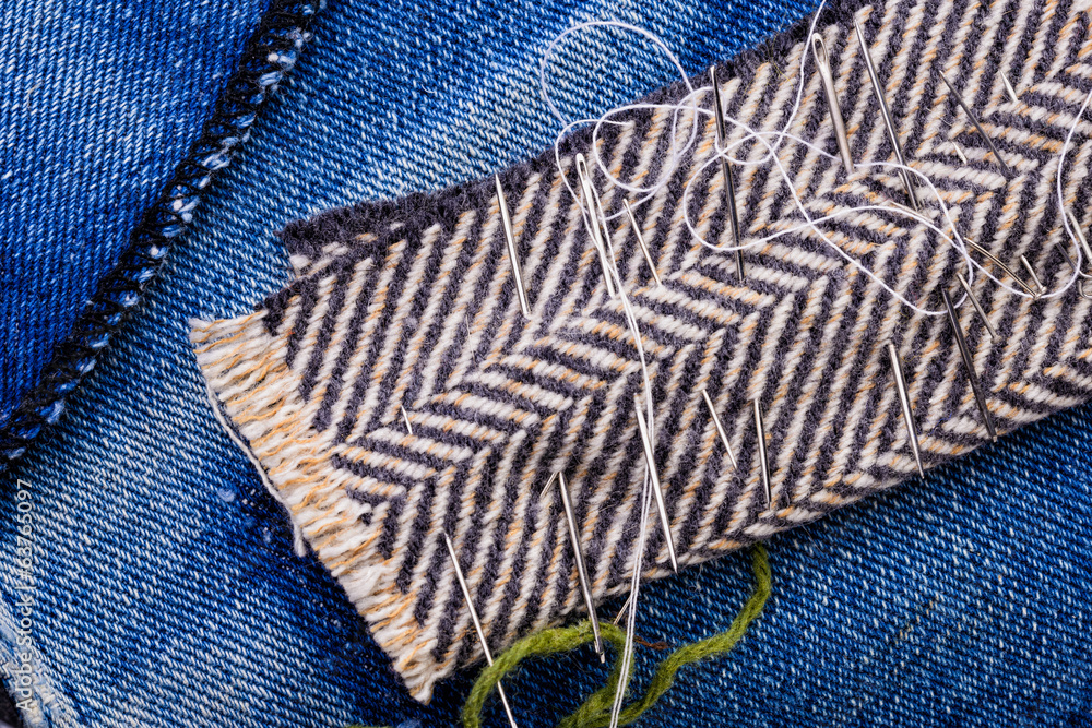 Various needles ready to needlework with blue jeans and fabric Various needles ready to needlework with blue jeans and fabric