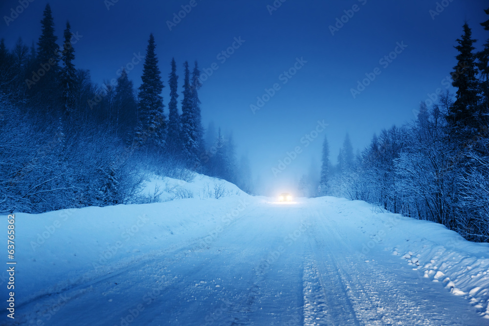lights of car and winter road in forest lights of car and winter road in forest