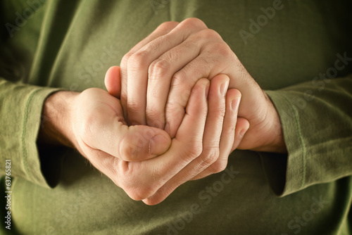 Man is hidding something in hands photo