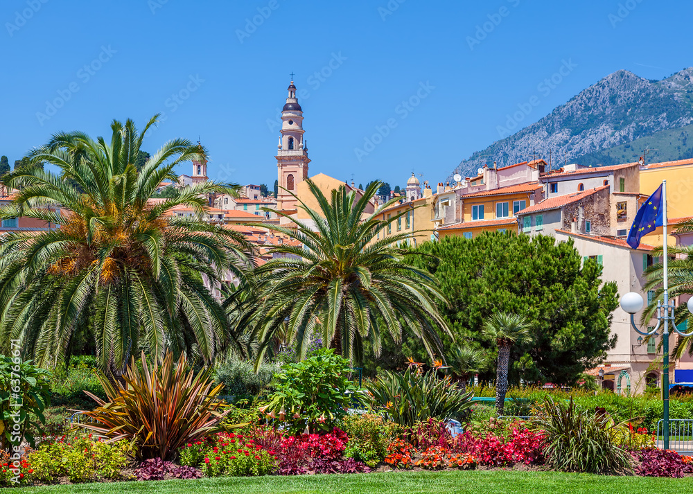 Colorful houses, green trees and palms in Menton.