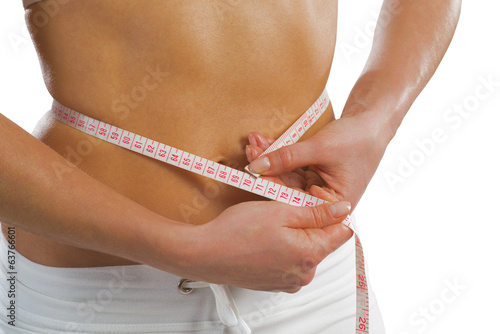 young athletic woman measuring waist