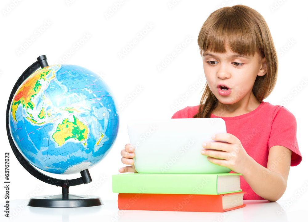 Young girl is using tablet while studying Young girl is using tablet while studying