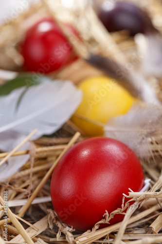 .Colourful traditional painted Easter eggs in the straw