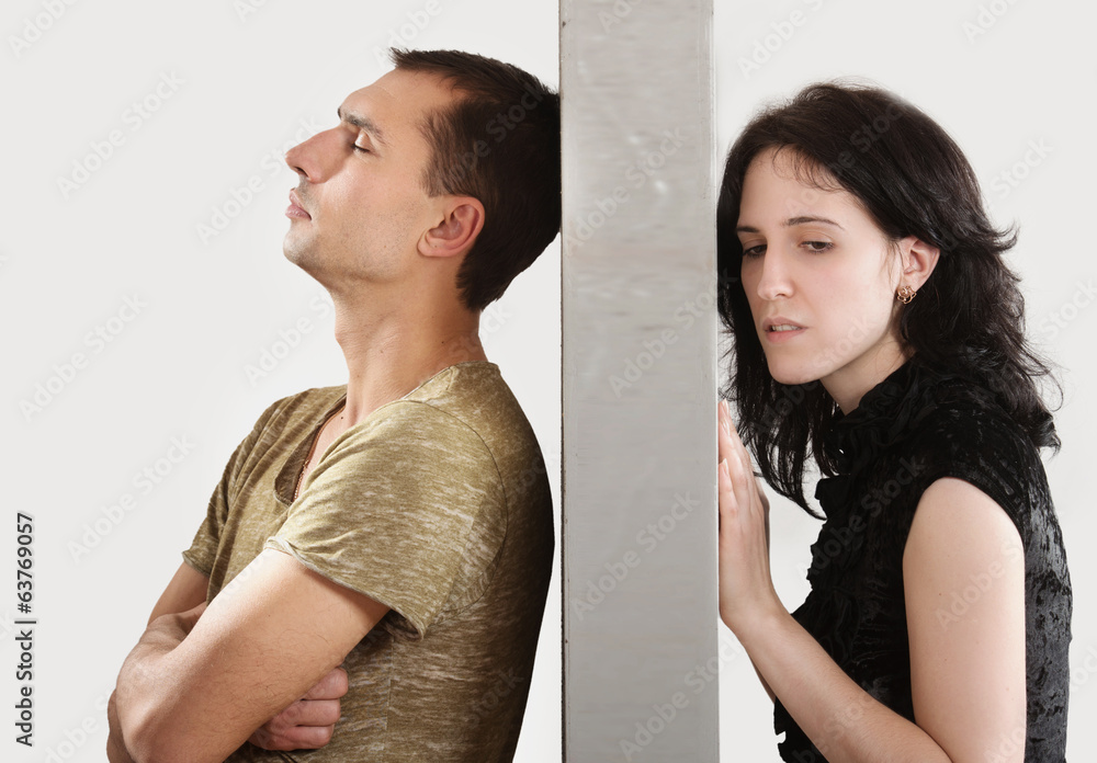 Conflict between man and woman standing on either side of a wall Stock ...