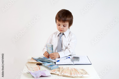 Young man, counting money and taking notes