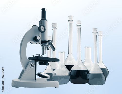 Laboratory metal microscope and test tubes with liquid toning in