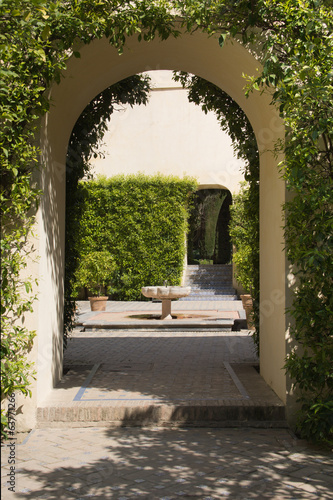 Arch in garden with fountain