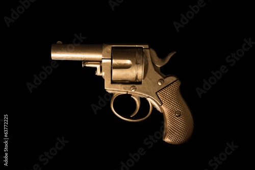 Old hand gun on a dark background