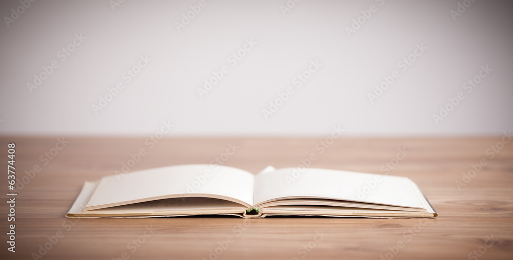 Obraz premium Open book on wooden deck