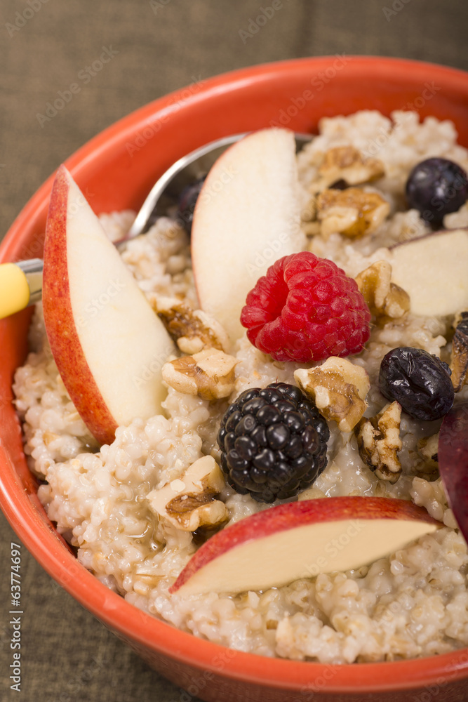 Bowl of steel cut oats served with fresh fruit and honey Bowl of steel cut oats served with fresh fruit and honey