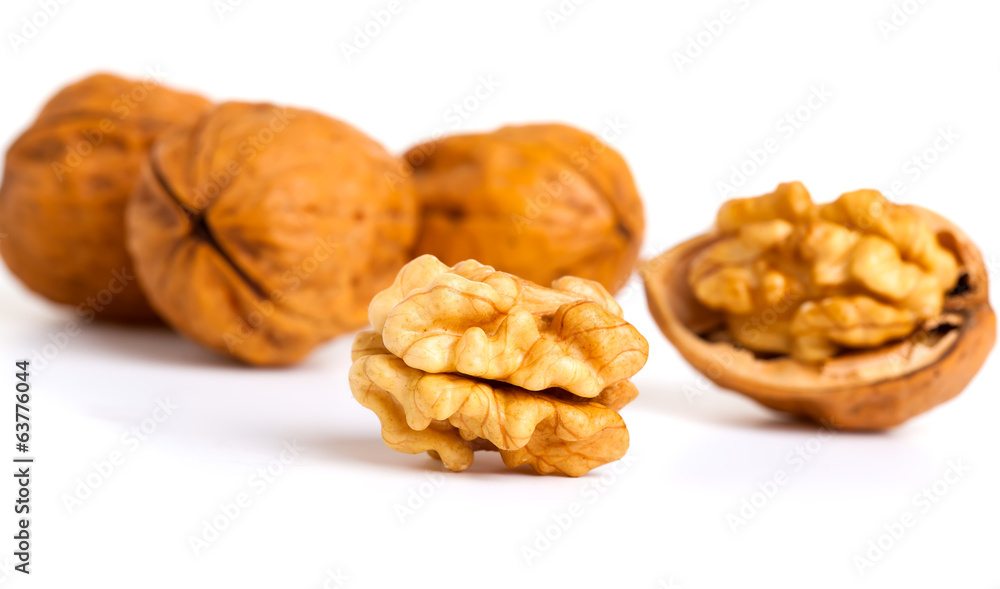 walnut and a cracked walnut isolated on the white background walnut and a cracked walnut isolated on the white background