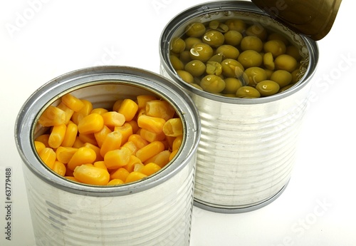 green peas and corn in a can on a white background