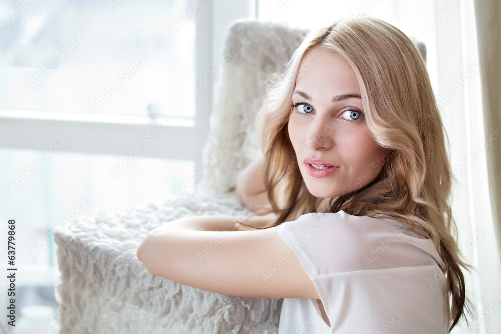Portrait of a beautiful female model near window Portrait of a beautiful female model near window