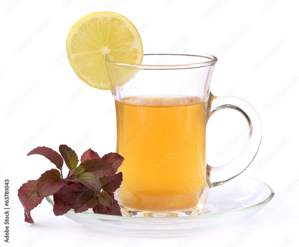 Cup of herbal tea with red tulsi leaves and lemon