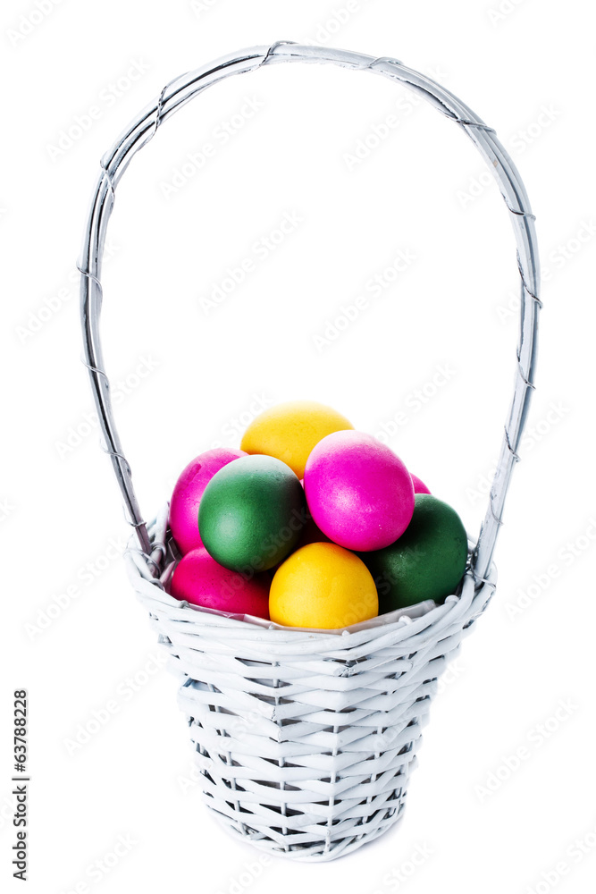Colorful easter eggs in basket isolated on white background clos Colorful easter eggs in basket isolated on white background clos